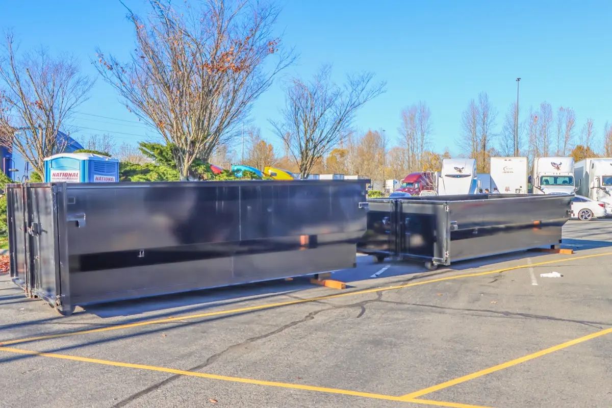 Professional dumpster rental service with roll-off container on residential driveway in DeForest